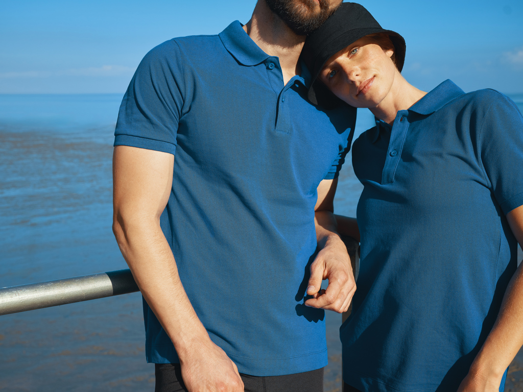 Couple portant des polos bleus au bord de mer