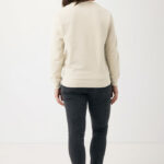 Femme portant jean noir et sweat beige.