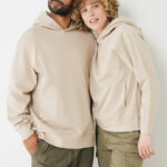 Couple portant sweats à capuche beiges assortis