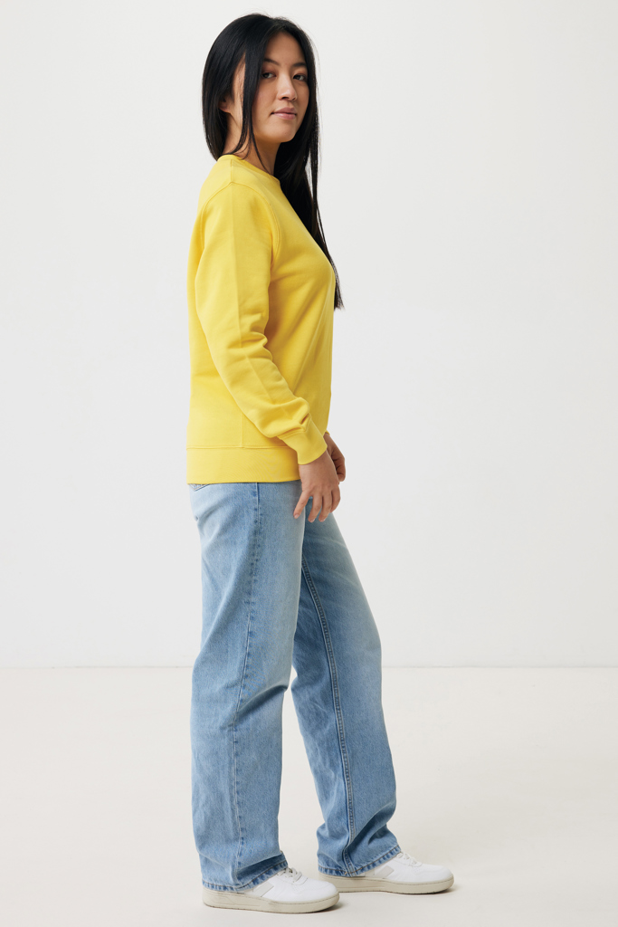 Femme en sweat jaune et jean clair