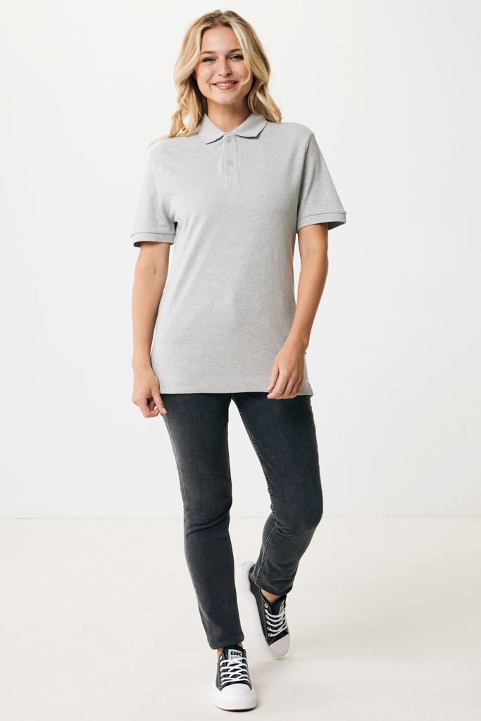Femme souriante en polo gris et jean foncé