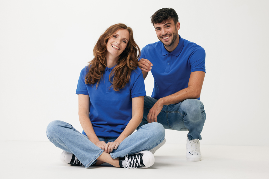 Homme et femme souriants en polos bleus