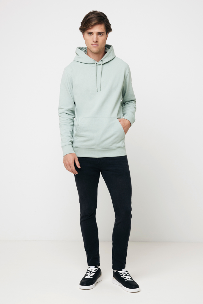 Homme portant hoodie vert clair et jean noir