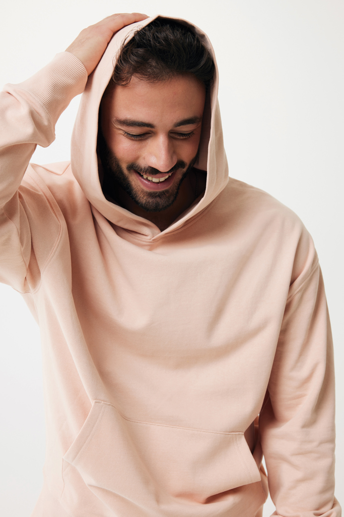Homme souriant en hoodie beige, fond neutre