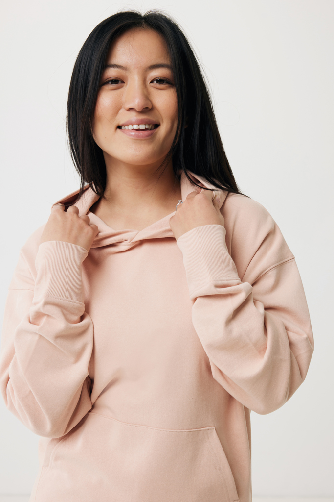 Femme souriante en sweat à capuche beige